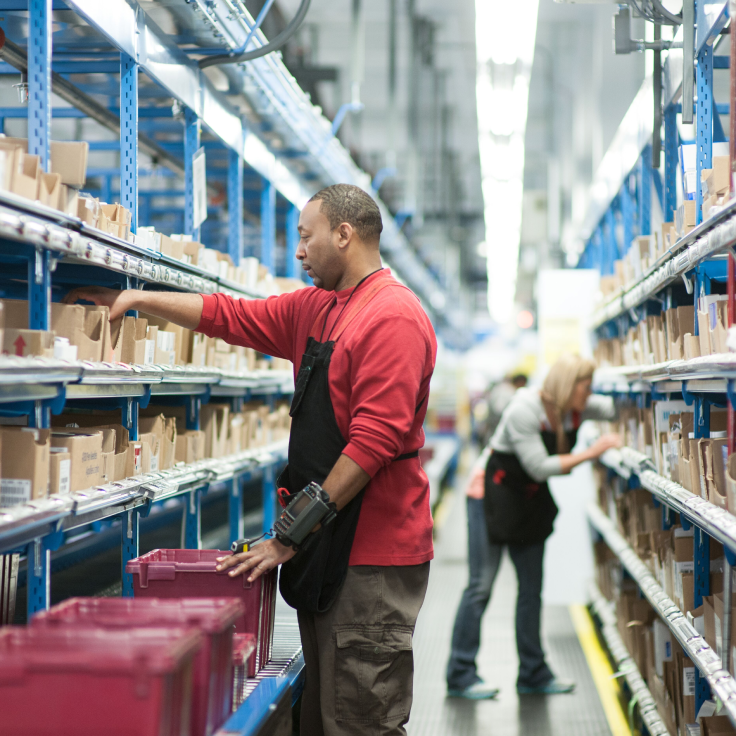 Image of medical distribution worker packing a shipment