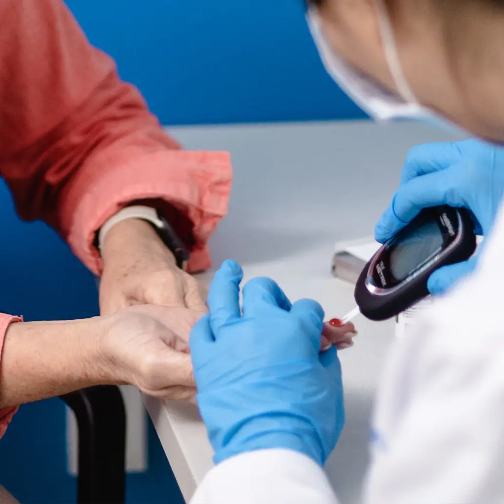 photo of a patient receiving a blood sugar glucose test