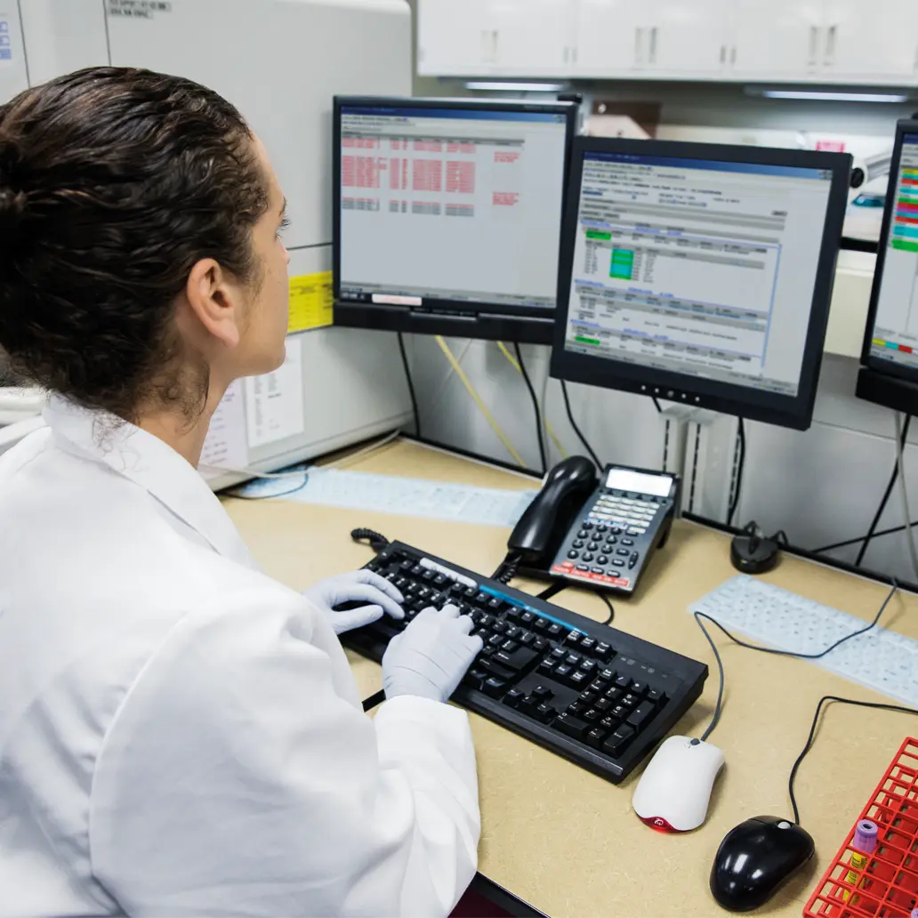 photo of lab technician using lab software