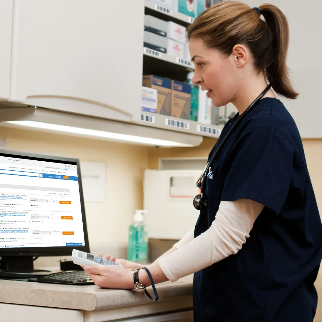 photo of female medical professional ordering more supplies using a McKesson ScanManager handhelf device and SupplyManager online