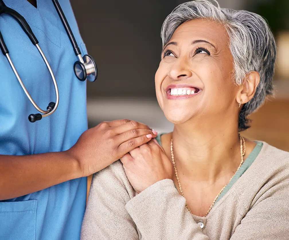 photo of a healthcare professional comforting an older female patient