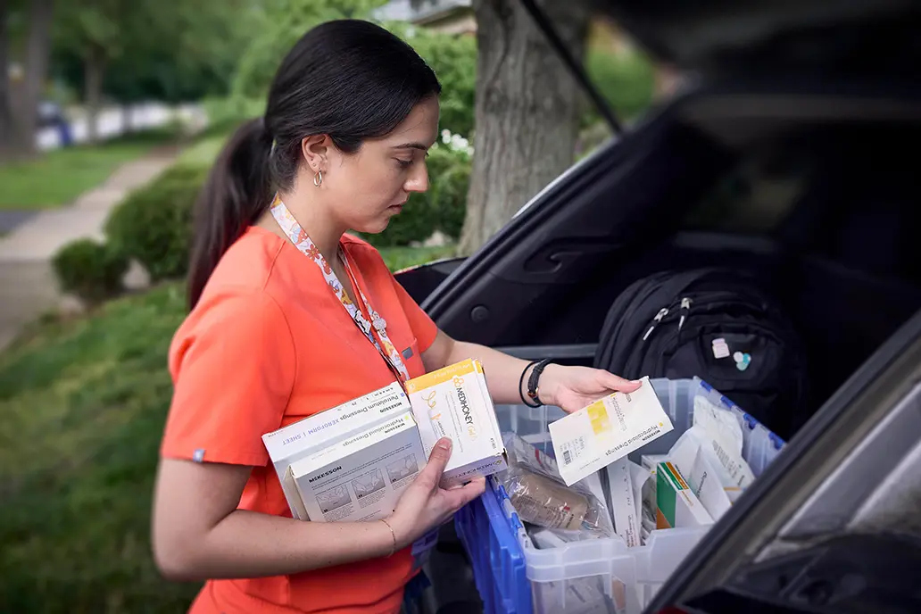 Photo of home health professional sorting medical supplies in her mobile HHA kit