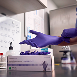 photo of someone putting on an exam glove