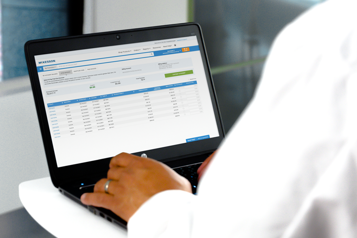photo of a person using a laptop with McKesson SupplyManager displayed on the screen