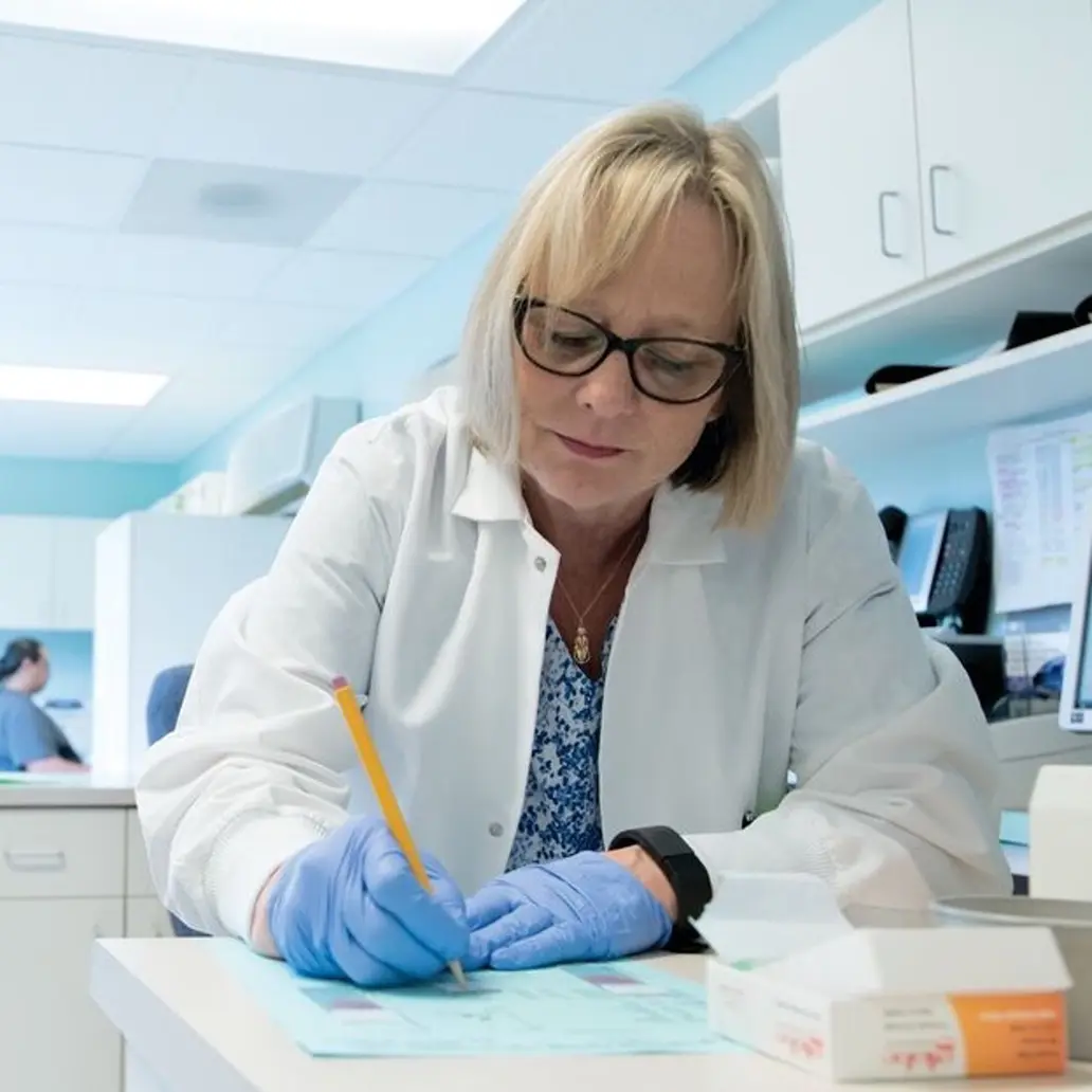 photo of a female medical professional working at a desk