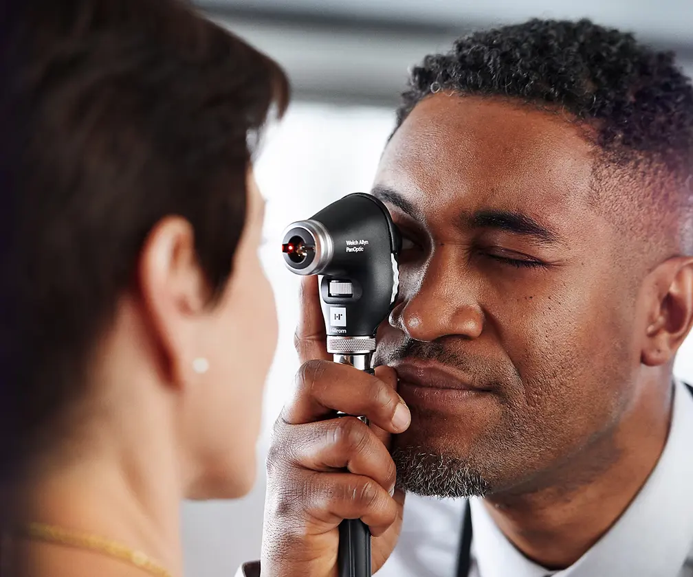 photo of a doctor examining a patient using a retinal device