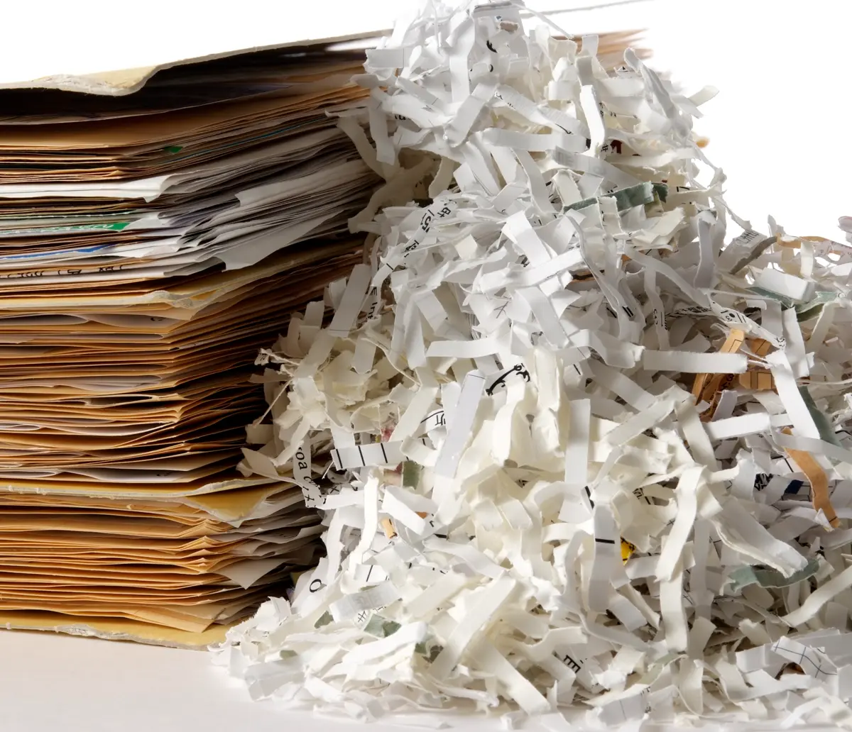 photo of shredded paper next to a stack of files
