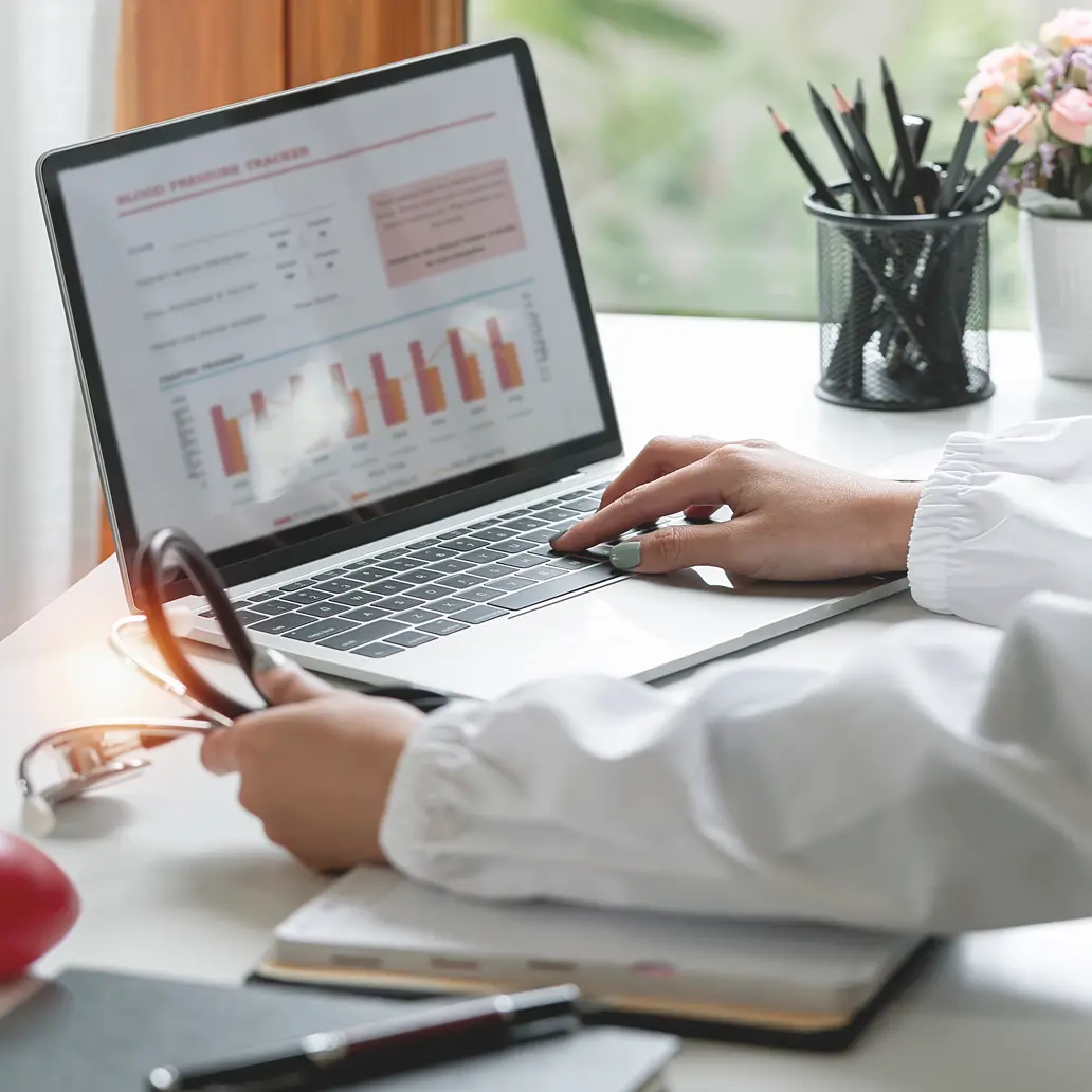 photo of a medical professional looking at their EHR dashboard on a laptop screen